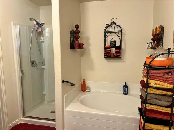 a bathroom with a tub and shower
