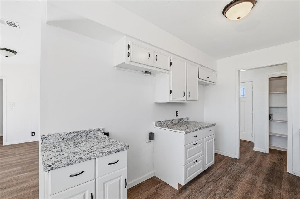 100 West Dilworth Road Italy, TX 76651 - Photo 11 of 38 a kitchen with granite countertop white cabinets and white appliances