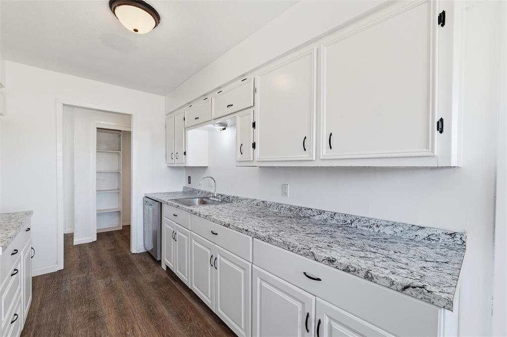 100 West Dilworth Road Italy, TX 76651 - Photo 12 of 38 a kitchen with granite countertop white cabinets and sink