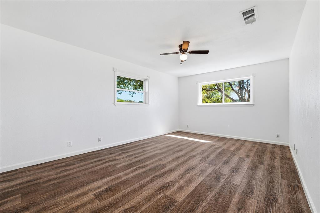 100 West Dilworth Road Italy, TX 76651 - Photo 19 of 38 a view of empty room with wooden floor and fan