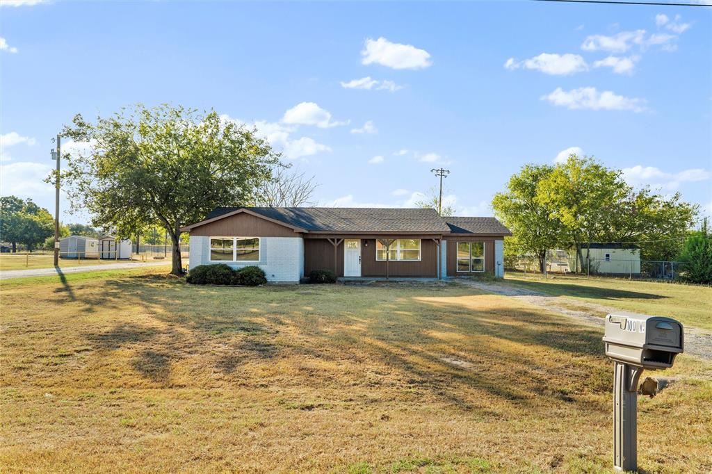 100 West Dilworth Road Italy, TX 76651 - Photo 34 of 38 a front view of a house with a yard and trees