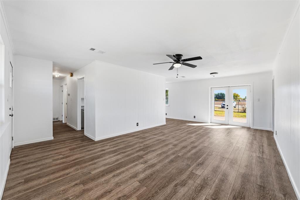 100 West Dilworth Road Italy, TX 76651 - Photo 4 of 38 wooden floor in an empty room with a window