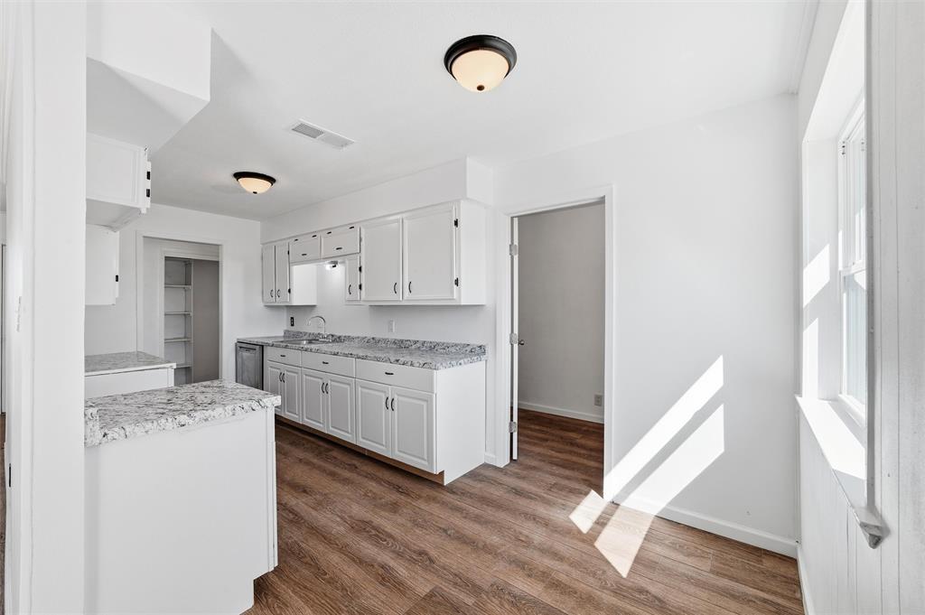 100 West Dilworth Road Italy, TX 76651 - Photo 8 of 38 a kitchen with a stove a sink wooden floor and entryway