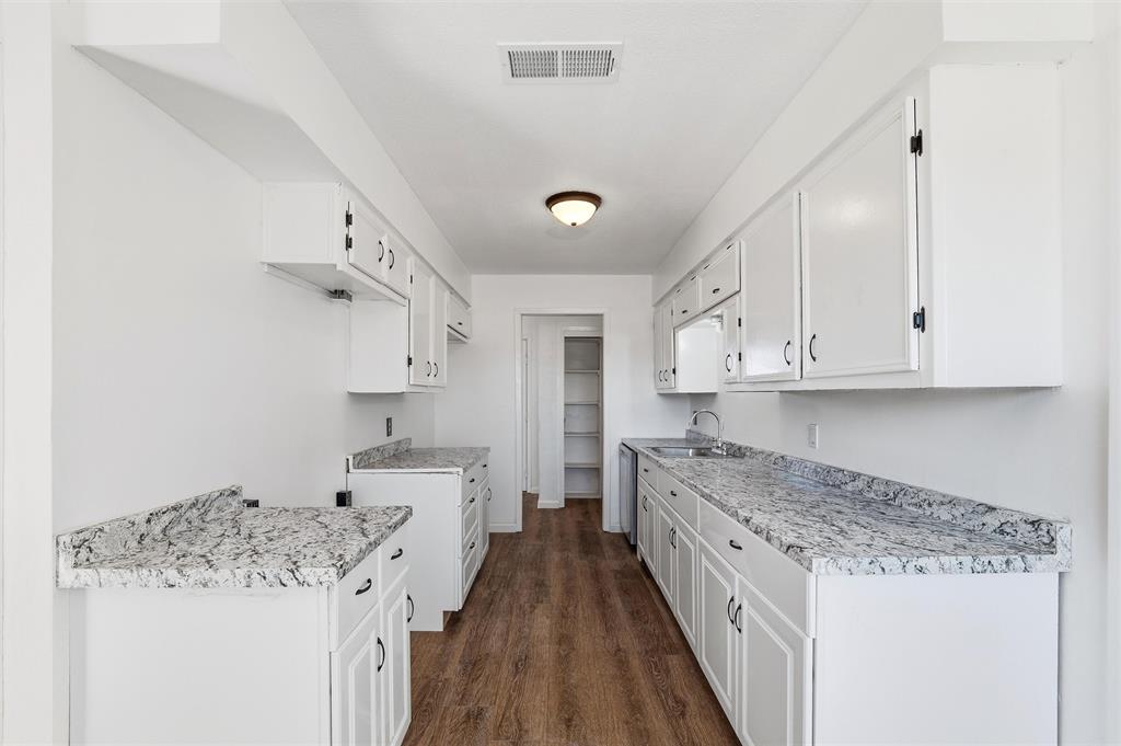 100 West Dilworth Road Italy, TX 76651 - Photo 10 of 38 a large kitchen with a stove and white cabinets