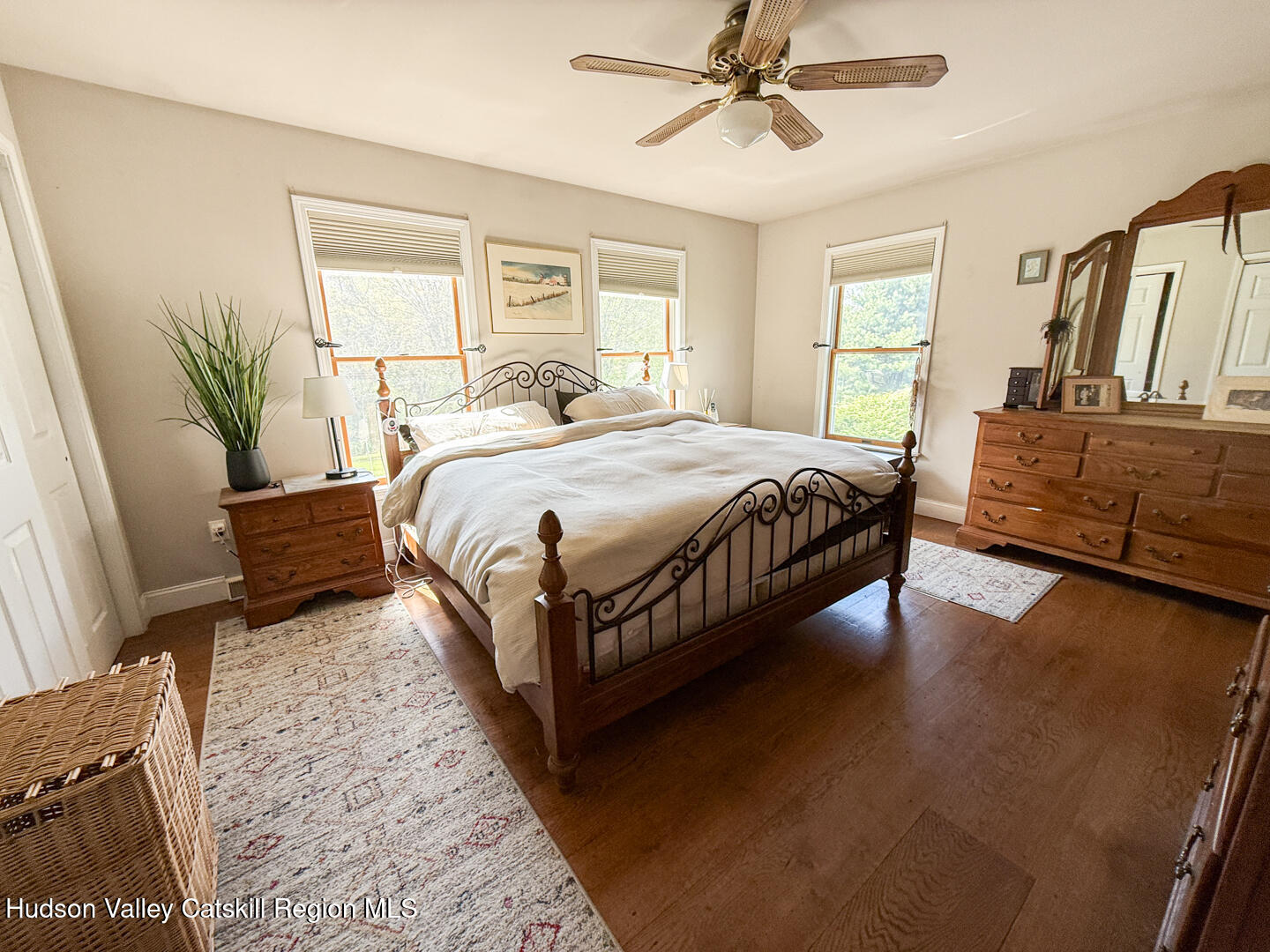 787 Co Rte 6 Germantown, NY 12526 - Photo 13 of 35 a spacious bedroom with a bed a couch and a potted plant on the dresser