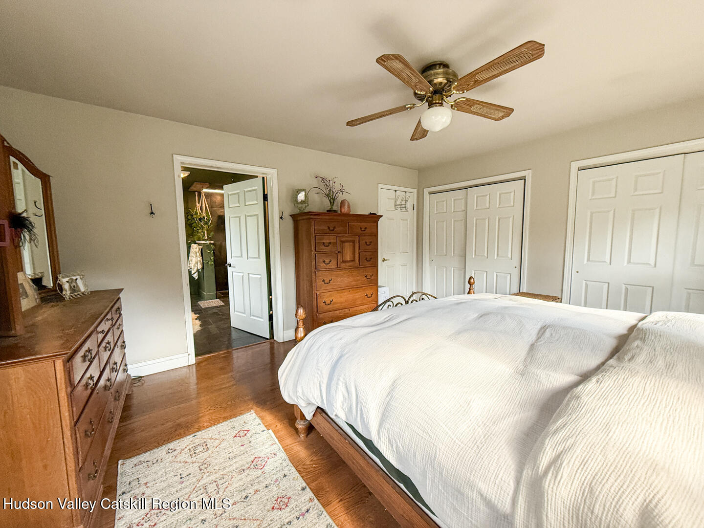 787 Co Rte 6 Germantown, NY 12526 - Photo 14 of 35 a spacious bedroom with a bed and a dresser with wooden floor