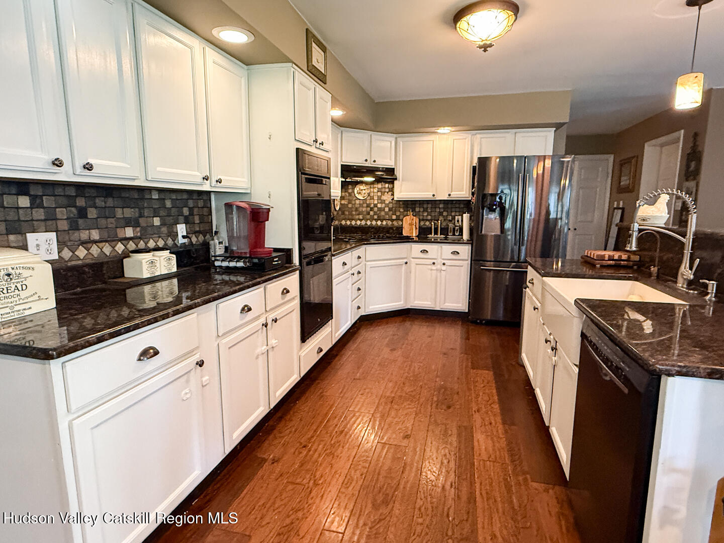787 Co Rte 6 Germantown, NY 12526 - Photo 6 of 35 a kitchen with stainless steel appliances kitchen island granite countertop a stove a sink and white cabinets with wooden floor