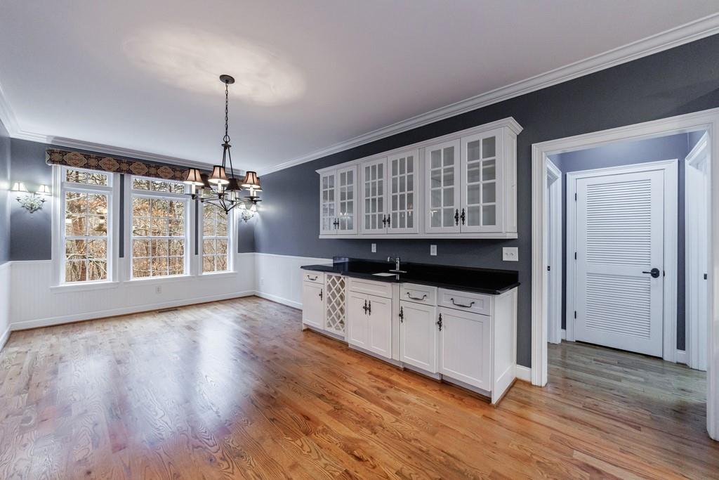 267 Sharp Mountain Parkway Jasper, GA 30143 - Photo 15 of 55 a kitchen with a sink wooden floor and a chandelier