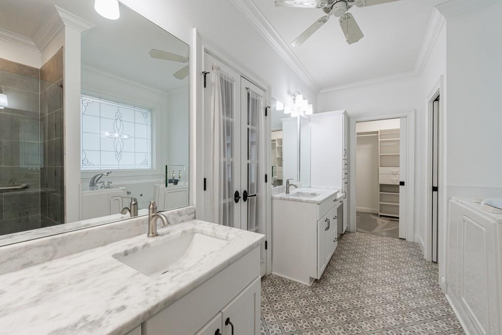 267 Sharp Mountain Parkway Jasper, GA 30143 - Photo 20 of 55 a bathroom with a granite countertop sink a mirror a vanity and a shower