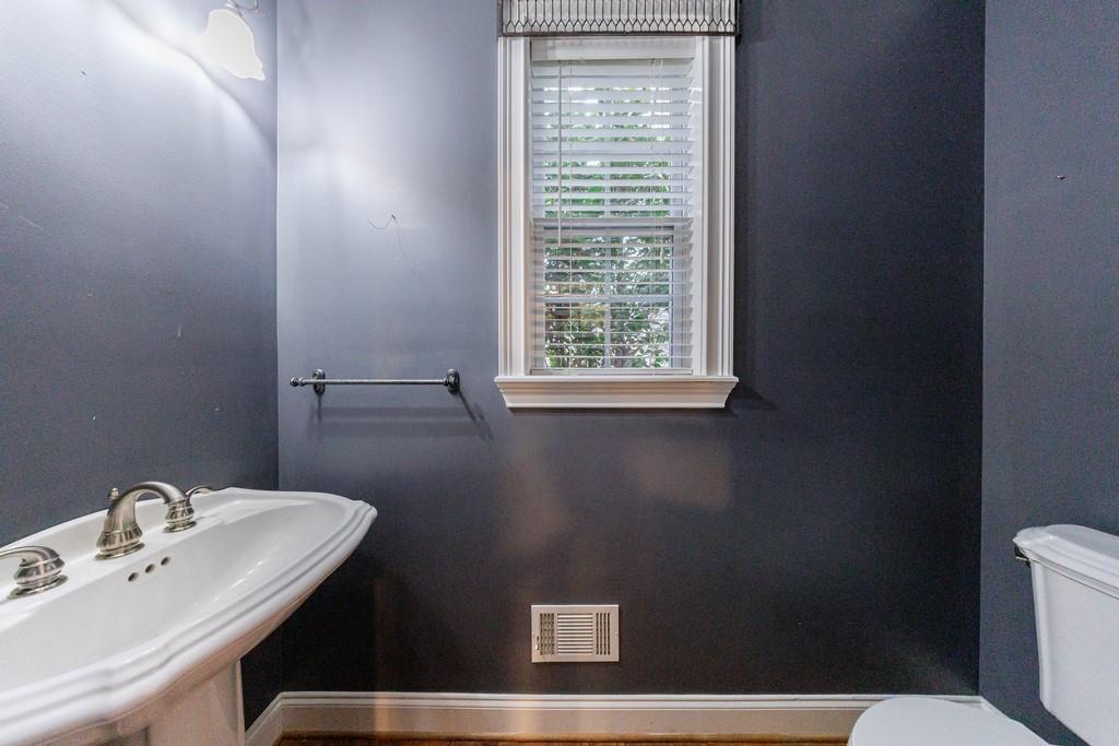 267 Sharp Mountain Parkway Jasper, GA 30143 - Photo 30 of 55 a bathroom with a sink a toilet and a mirror