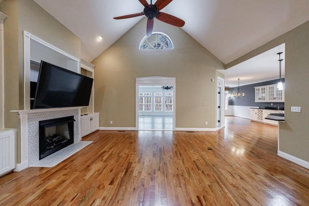 267 Sharp Mountain Parkway Jasper, GA 30143 - Photo 7 of 55 a view of empty room with wooden floor and fireplace