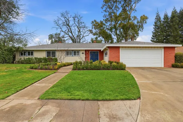 a front view of house with yard and green space