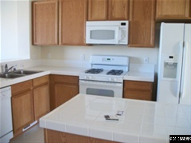 415 Preston Burr Lane Reno, NV 89503 - Photo 4 of 9 a kitchen with a cabinets and white appliances