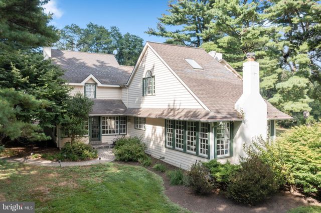 a aerial view of a house with yard and green space