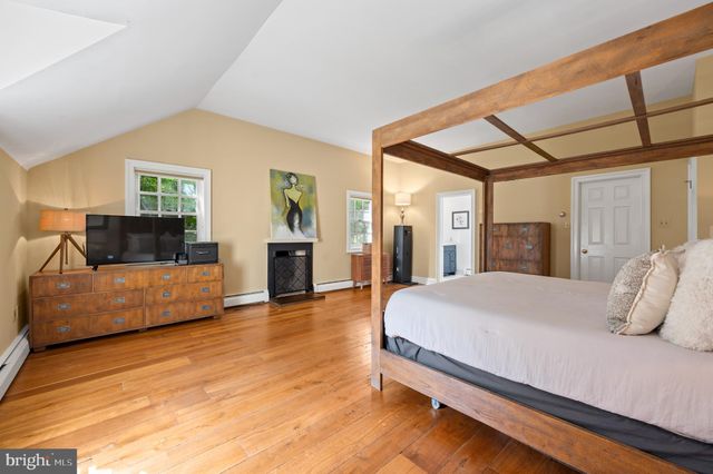 a spacious bathroom with a toilet sink and mirror