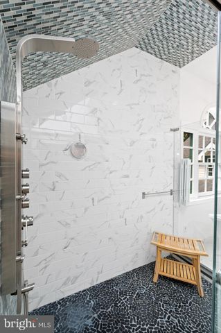 a view of a bedroom with furniture and a window