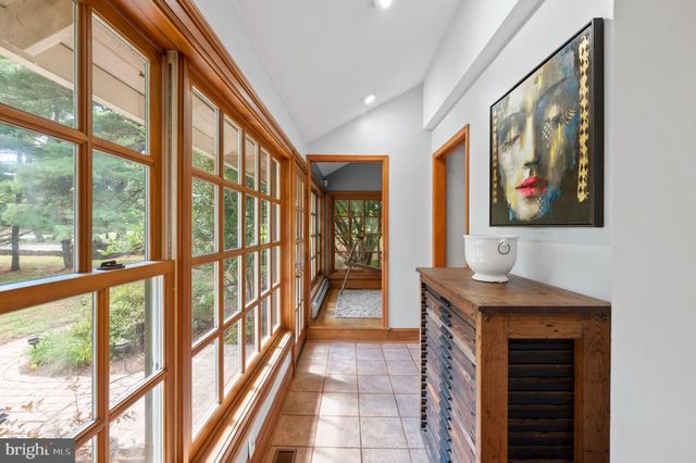 a view of a hallway with wooden floor and cabinet