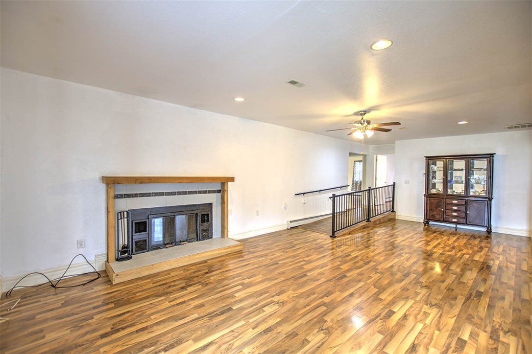 4402 East Rosewood Drive Decatur, IL 62521 - Photo 11 of 23 a view of an empty room with wooden floor fireplace and a window