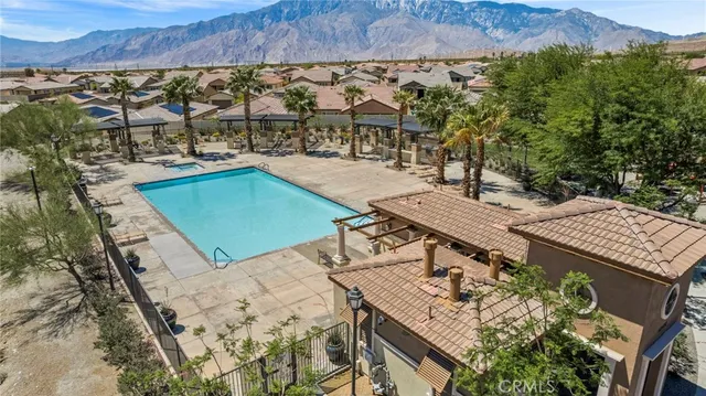 an aerial view of a house with a yard and lake view