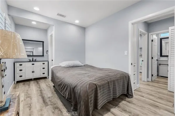 a bedroom with a bed and a mirror