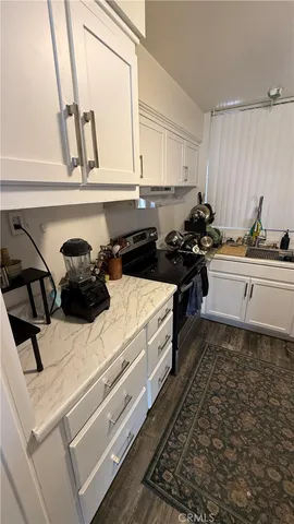 a kitchen with a sink appliances and cabinets