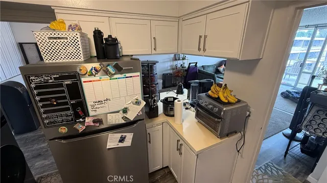 a kitchen with white cabinets and sink