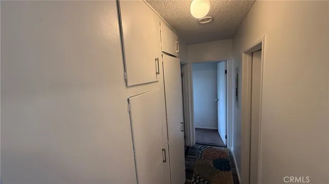 a view of a balcony with wooden floor and iron fence