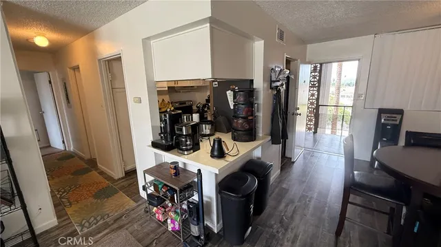 a view of a kitchen with fridge and workspace