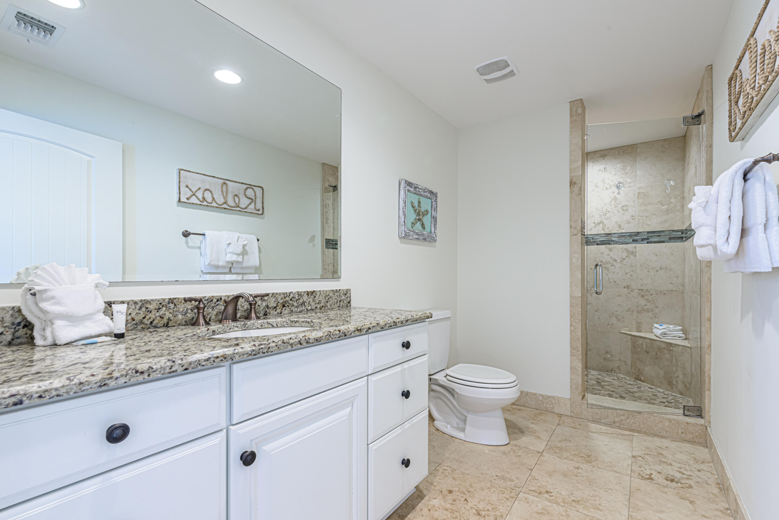 281 Elm Street Santa Rosa Beach, FL 32459 - Photo 18 of 37 a bathroom with a granite countertop sink a toilet and a shower