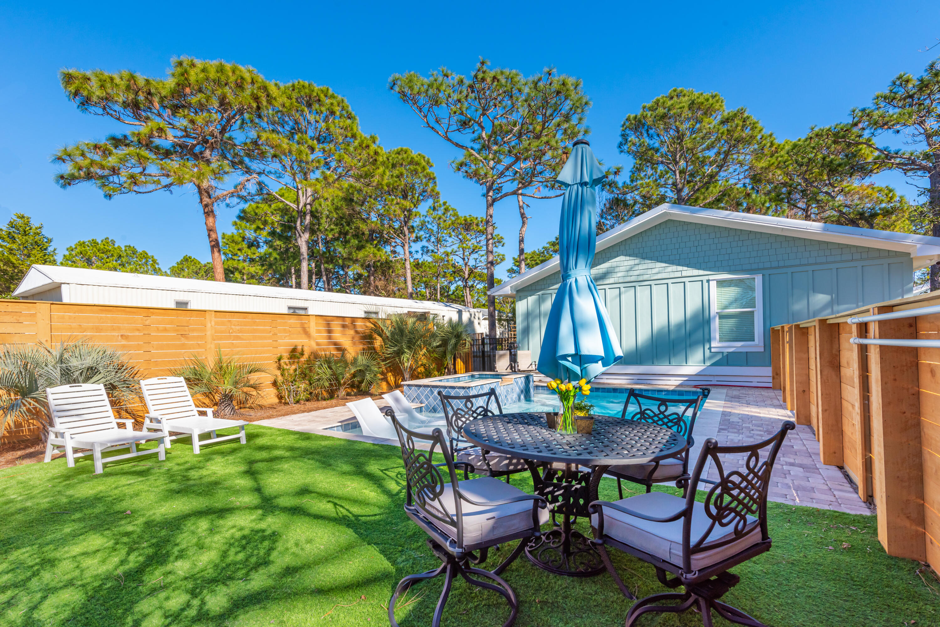 281 Elm Street Santa Rosa Beach, FL 32459 - Photo 26 of 37 a view of a chairs and table in the garden