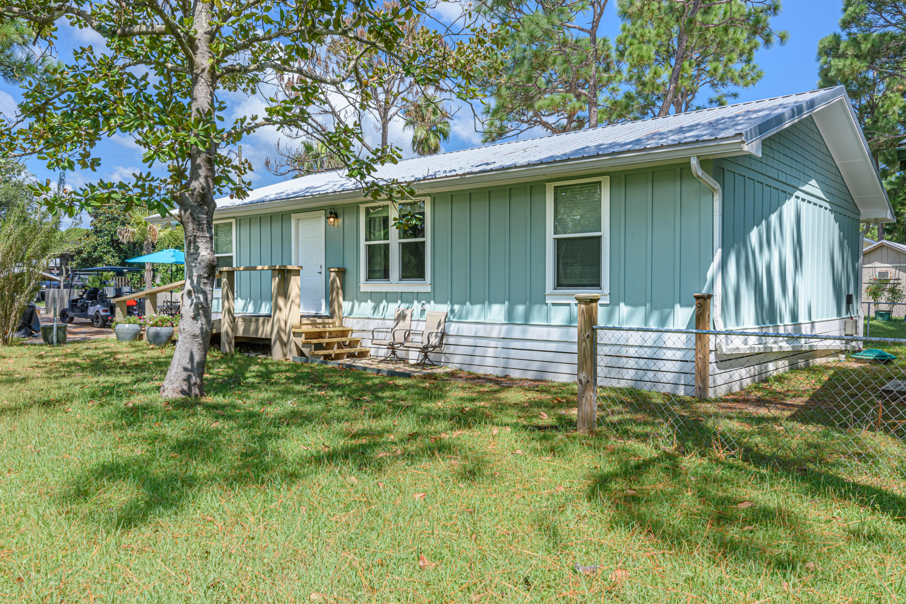 281 Elm Street Santa Rosa Beach, FL 32459 - Photo 4 of 37 a view of a house with backyard and sitting area