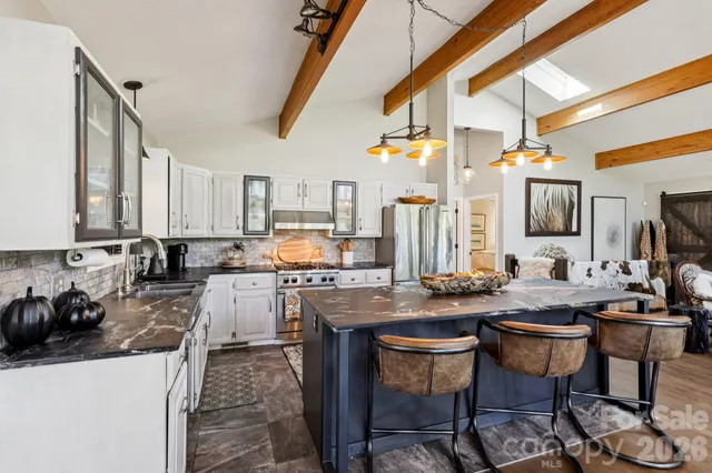 a bedroom with a bed a couch and a window