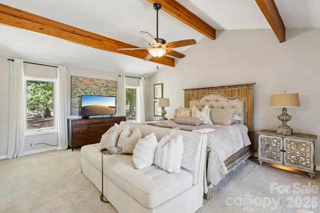 a spacious bathroom with a granite countertop sink a toilet a mirror and shower