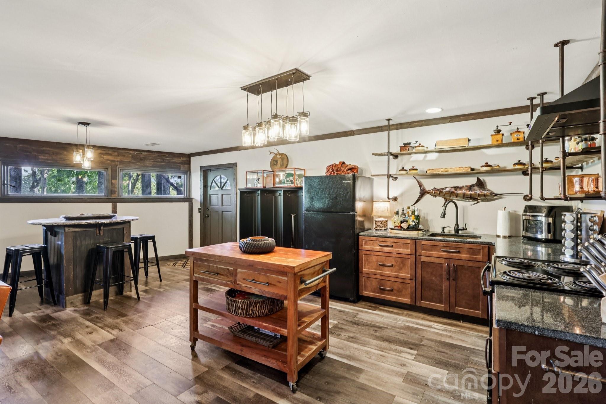 44333 Stony Gap Road Albemarle, NC 28001 - Photo 20 of 28 a kitchen with a stove a refrigerator and a dining table