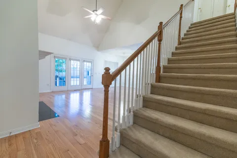 an empty room with a ceiling fan and a window