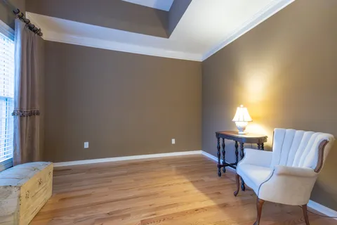 a workspace room with furniture and window