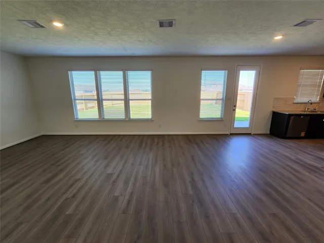 a view of kitchen with cabinets and wooden floor