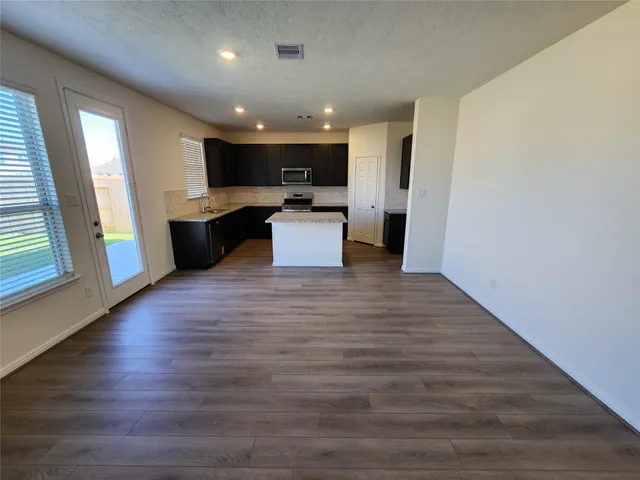a bathroom with a bathtub shower sink vanity and toilet