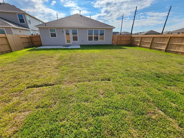 a view of a house with a backyard