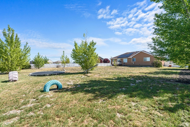 444 South Saddle Road Grantsville, UT 84029 - Photo 26 of 33 Expansive yard featuring mature trees and a white privacy fence