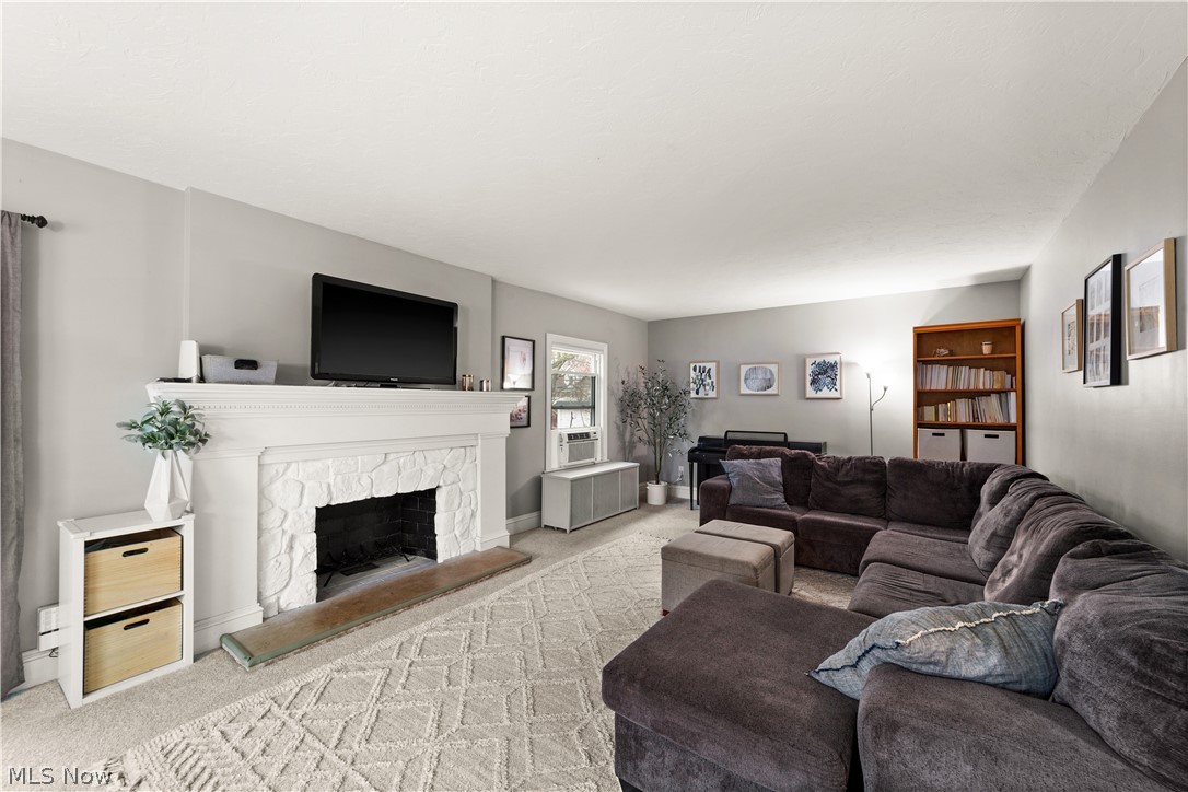 1680 Lee Road Cleveland, OH 44118 - Photo 7 of 45 Living room featuring a stone fireplace and light carpet