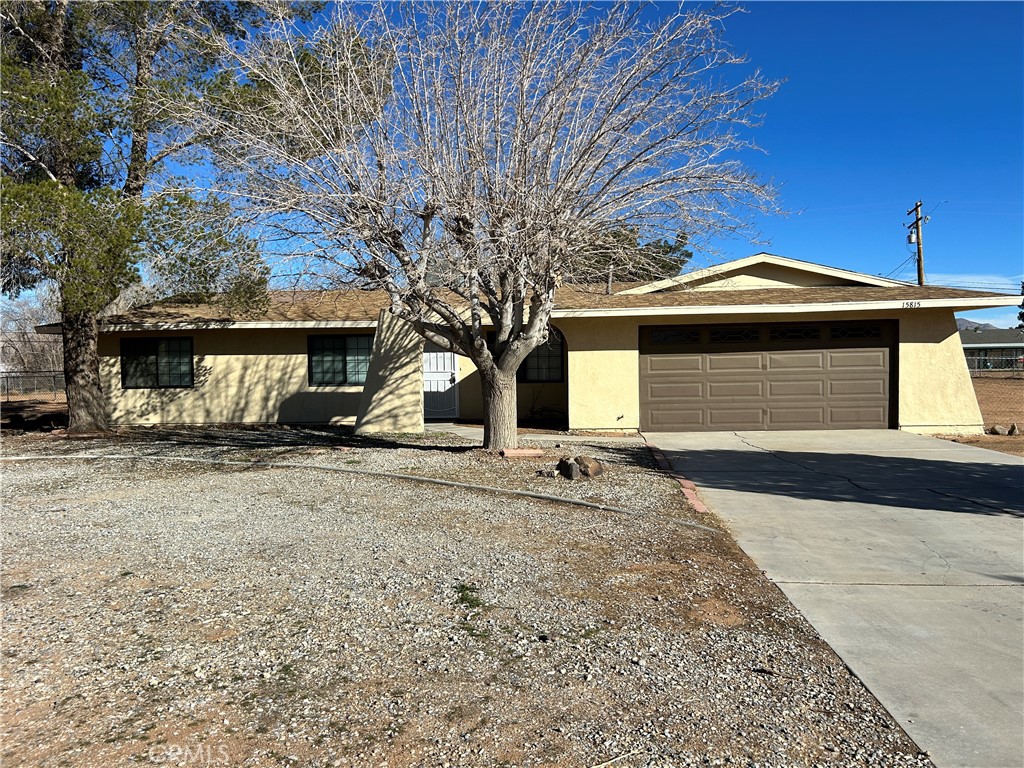 15815 Wichita Road Apple Valley, CA 92307 - Photo 1 of 1 a front view of a house with a yard and garage