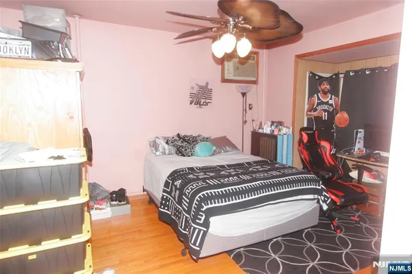 a bedroom with a bed and a chandelier