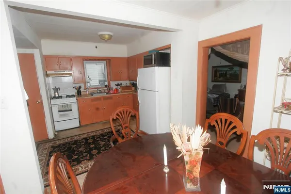 a room with stainless steel appliances furniture a refrigerator and a window