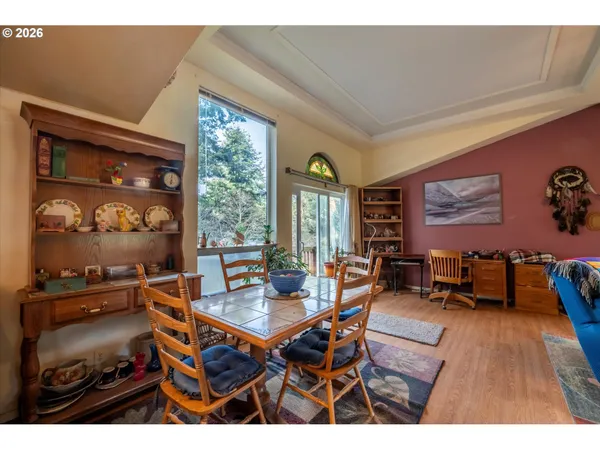 a dining room with furniture and wooden floor