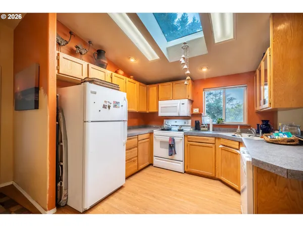 a kitchen with cabinets appliances and a counter space