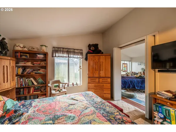 a bedroom with furniture and a flat screen tv