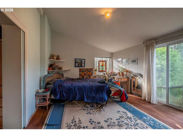 a bedroom with furniture and a wooden floor