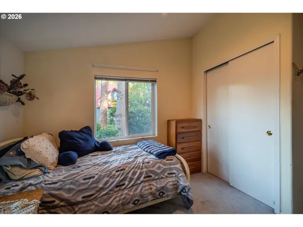 a bedroom with a bed and a window