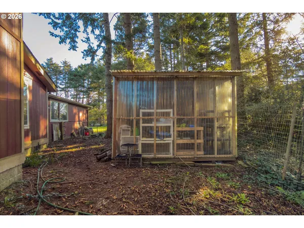 a view of a wooden house with a yard